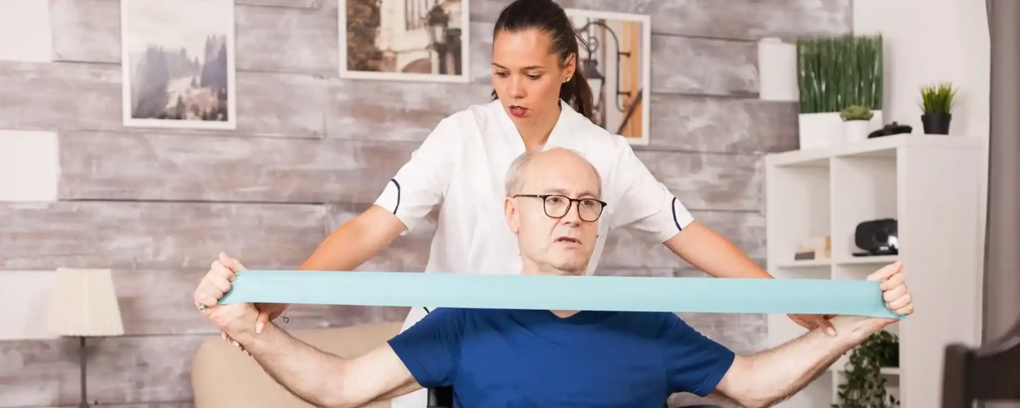 old-man-doing-muscle-injury-exercise-using-resistance-band-with-nurse-beside_482257-109 (1) (1)